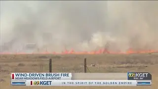 Wind-driven brush fire near Meadows Field Airport