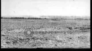 British artillerymen advancing with horse-drawn artillery guns, under German fire...HD Stock Footage