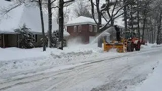 Larue D50 loader-mounted snow blower clearing the street in Quebec City