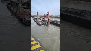 Excavator on Barge Dredging the River