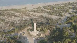 D-Log M. Gelemis, Turkey. Restored ancient lighthouse in Patara landscape, stone tower on coast w...