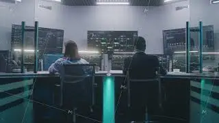 Software programmers work on computers in monitoring control room