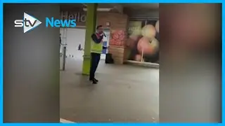Supermarket staff sing to entertain queuing shoppers