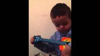 Enfant 3ans chante et joue guitare