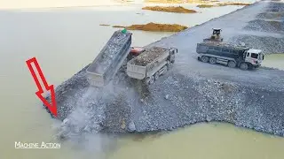 New Road on Water By KOMATSU Bulldozer Clearing Stone with Truck Unloading Big Stone