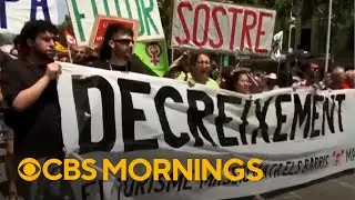Demonstrators in Spain protest against mass tourism, spraying tourists with water guns