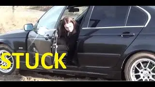 Women Black BMW Stuck in Mud