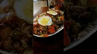 mixed meat and vegetable chop suey fried rice with fried eggs