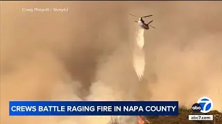 Crews battle raging wildfire in California's wine country