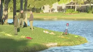 Divers with Broward Sheriff’s Office continue searching Deerfield Beach lake