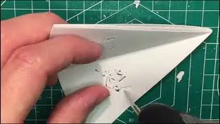 Cutting paper into a Pumbaa (Lion King) snowflake