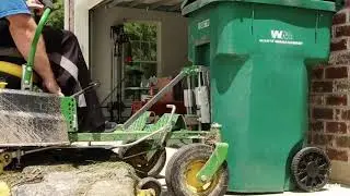 Custom built trash can lift in operation.
