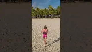 Fit Woman Walking On Tropical Beach With Yoga Mat In Morning Light