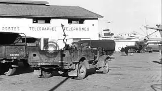 Allied military equipment and trucks being unloaded by British at a port in North...HD Stock Footage