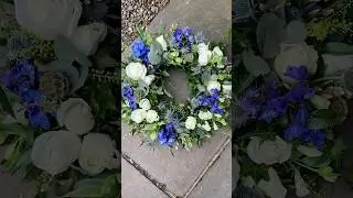 Creating a striking funeral wreath in blue and white #floraltribute #funeralflowers #florist