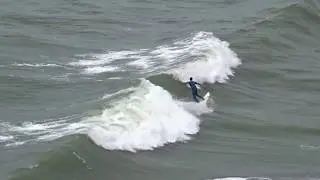 Surfing in the sea off wonderful Llangrannog beach in Ceredigion Cymru (Wales)