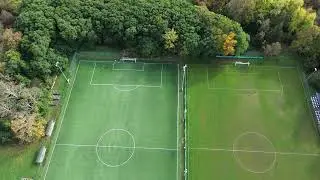 Football field, forest - Free drone stock footage