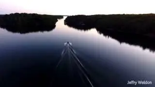 Flat calm aerial cruise into Lake of the Isles
