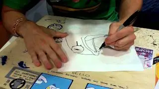 Dan Paladin of The Behemoth drawing characters for me at SDCC 2011