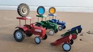 Green colour john Deere tractor and blue colour tractor trolley fitting and moving at beach 