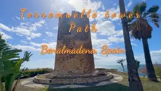 Walking by the Torremuelle tower in Malaga, Spain