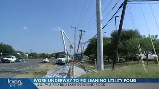 Leaning utility poles being fixed along US 79 in Round Rock