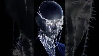 Frontal Portrait of a figure, bald, blackclatex eyes, glass tears stream down her face, and face ...