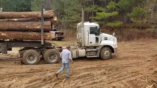 Mack Truck Pulling a Hill loaded with Logs