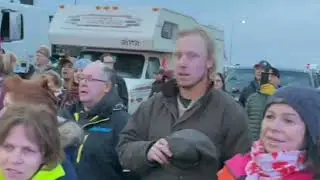 Coutts, Ab, Canada TruckerConvoy Sing Oh Canada While Embracing Law Enforcement On Valentine Day