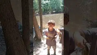 Twin boys show off their catch during fishing trip in North Alabama, USA