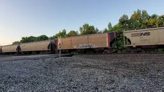 An NS trio moves the long grain train past mile post 227