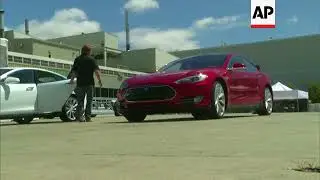 Electric car maker Tesla Motors unveiled its first mass-market, five-seat sedan vehicle on Friday, a