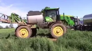 John Deere R4045 Sprayer pulls a Mack MaxiCruise Truck out of the Mud