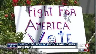 Vet Holds Sign to Encourage Voting