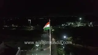 Giant Indian Flag Night-time Aerial view along dark and lit up stretches of Indian highway in India