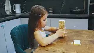 In her cheerful kitchen, a young girl joyfully plays with colorful wooden blocks, highlighting her