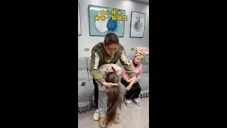My daughter is combing her hair and her father does it perfectly.