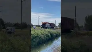WAMX GP40-3 number 4040 with a BNSF covered hopper
