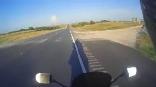 Van passenger throws water bottle at biker, biker responds