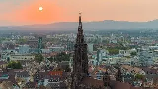 The landmark of Freiburg in sunset light (M&uuml;nster) | Aerial (6K)