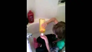 Kyrstian giving Reginald a bath