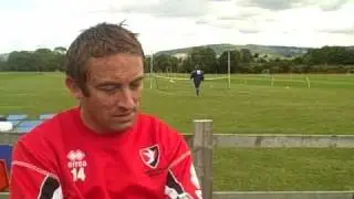 Cheltenham Town midfielder JJ Melligan talks to Jon Palmer