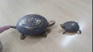 An antique mechanical brass hotel desk bell in the form of a turtle
