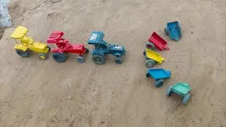 The tractor trailer is parked in front of the tractors.#127