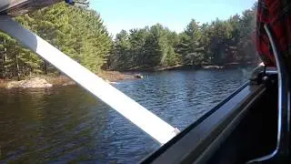 Cessna A185F on floats, taking off.
