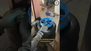 Workers use stamping machines to press aluminum alloy wheels onto solid rubber tires