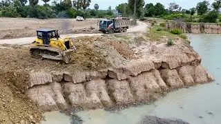 Be Careful When Pouring Soil into Deep Pond with Dump Truck and Bulldozer Push Soil Down into Pond