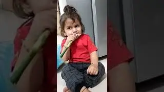 Cute Baby is eating Spring Onion in his Own Style.