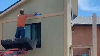 Affixing insulation and siding to the exterior of a CEB wall.