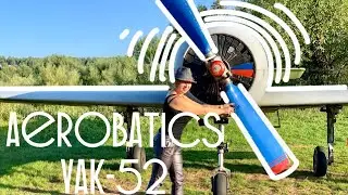 Flying aerobatics above river Volga on a Yak-52 training sports aircraft. 4K